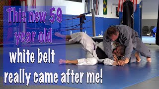 A hard round with a 59 year old white belt