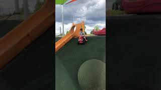 Boy rides toy ATV down hill then falls forward and lands on the ground