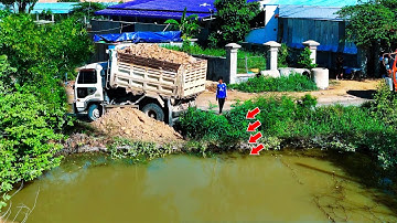 Amazing skill bulldozer pushing soil and filling land with dump trucks