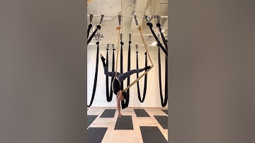 Aerial yoga hammock static flow with cross back straddle inversion
