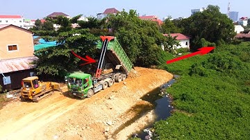 Great job!! Heavy dump truck soil Filling up building new Road /Dozer mini pushing soil into water
