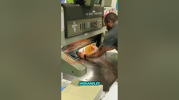 Guillotine paper cutter operator mishandle.