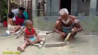 Rural life of Bd | Grandfather and grandson are busy with village work.