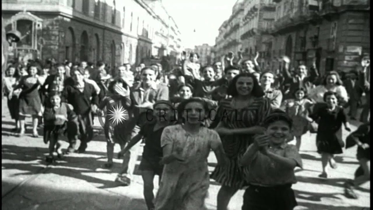 Civilians give a warm welcome to Allied troops in Naples, Italy during