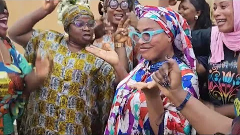 FAITHIA BALOGUN DANCES WITH FRIENDS IN PREPARATION FOR HER FATHER’S FINAL BURIAL CEREMONY