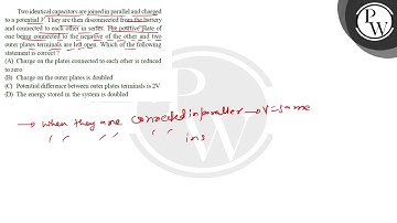 Two identical capacitors are joined in parallel and charged to a po...