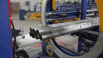 Horizontal orbital stretch wrapper for steel tube