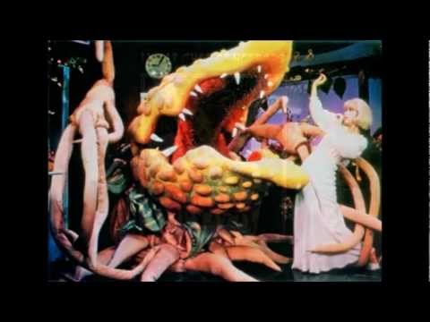 A very special find! Here is the first act of Little Shop of Horrors, performed by the original off-Broadway cast. This recording, recorded by an audience member, was probably recorded on October 14, 1982. (The .mp3s I found sounded slightly sped up. Though I did slow it down somewhat, I mainly pitched it down to get rid of the "helium" effect.) Accompanying the audio is pictures from the production, as well as the rehearsal process. The cast includes Lee Wilkof as Seymour, Ellen Greene as Audrey, Ron Taylor as Twoey, Hy Anzell as Mr. Mushnik, Franc Luz as Orin (and others), Leilani Jones as Chiffon, Jennifer Leigh Warren as Crystal, and Sheila Kay Davis as Ronette. ************** TRACKLIST ************** 00:00 Prologue/Little Shop 04:01 Skid Row (Downtown) 10:16 Da Doo 13:27 Grow for Me 16:09 Ya Never Know 21:11 Somewhere That's Green 25:40 Closed for Renovations 30:28 Dentist! 34:20 Mushnik & Son 36:58 Sudden Changes 38:33 Feed Me (Get It) 44:25 Now (It's Just the Gas) 47:28 Act I Finale (Coda) To download mp3s of the entire act, click here: bit.ly