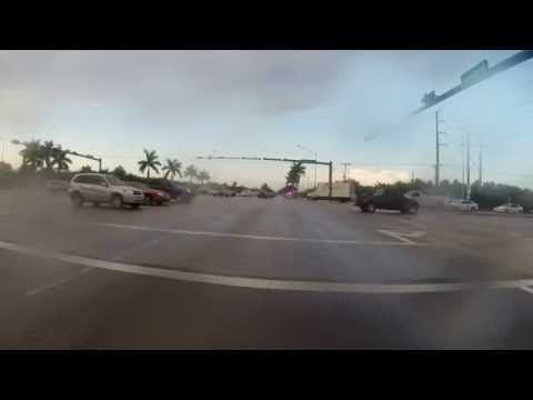 Truck turning left skids out on wet pavement and almost hits police 05/13/14