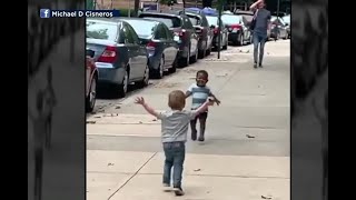 All the feels: Toddler boys run to give each other a great big hug