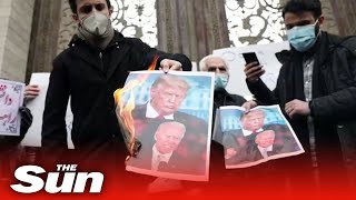 Iran vows to 'respond' to killing of scientist as protesters burn photos of Trump