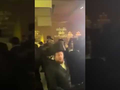 People Dancing and Spinning Under Vibrant Bar Lights