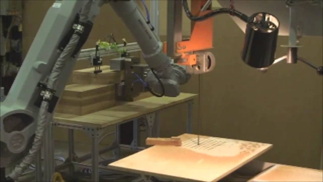 Motoman robot cutting guitar bodies YouTube