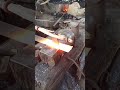 the process of splitting iron material to make palm oil hoe, a tool for harvesting oil palm fruit