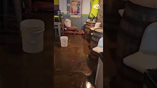 Driver wades through waist high floodwater after vehicle gets stuck