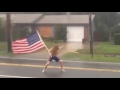 Florida crazy man challenges hurricane matthew with american flag in hand