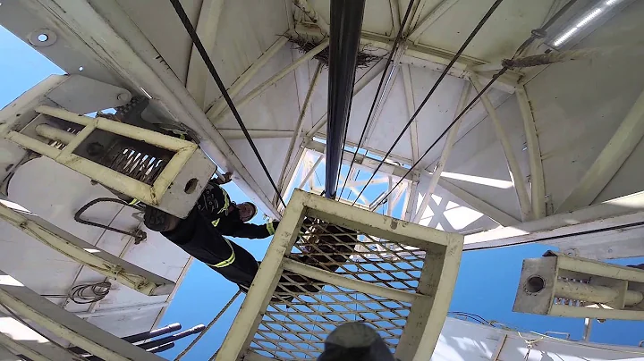 Derrickman on a drilling rig using fall protection...