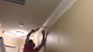 Tito and Noel finishing crown moulding, chair rail and shadow boxes job