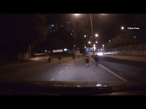 Dashboard camera shows cyclists endangering themselves