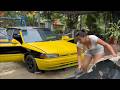 The girl is busy repairing and cleaning the engine of the yellow car