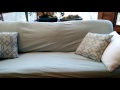 Cover a couch with bed sheets for a fresh clean look! This is my 1st attempt.