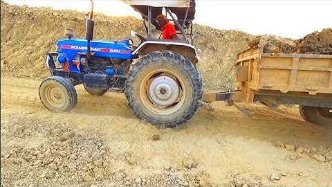 jcb3dx machine on mud loading powertrac tractor jcb loading for tractor