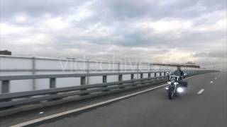 Biker Rides on Classic Motocyle on the Highway