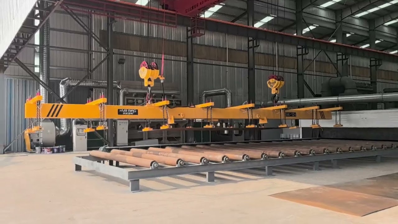 Magnetic lifting beam in action, effortlessly lifting steel plates. 
