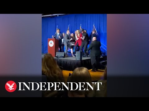 Moment protesters run on stage during Ron DeSantis speech