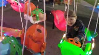 малыш катается на каруселе baby rides on a carousel