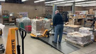 Using a pallet jack to unload a pallet wrapper