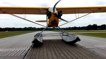 Launching the J-3 Cub on floats from a trailer at the airport