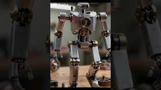 highly detailed mechanical walking robot toy made of polished metal gears, brass joints,