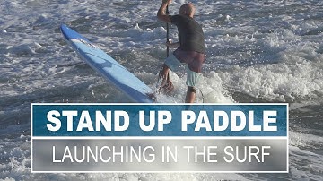 Launching a SUP in the Surf