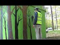 Covering bus stop with trees mural