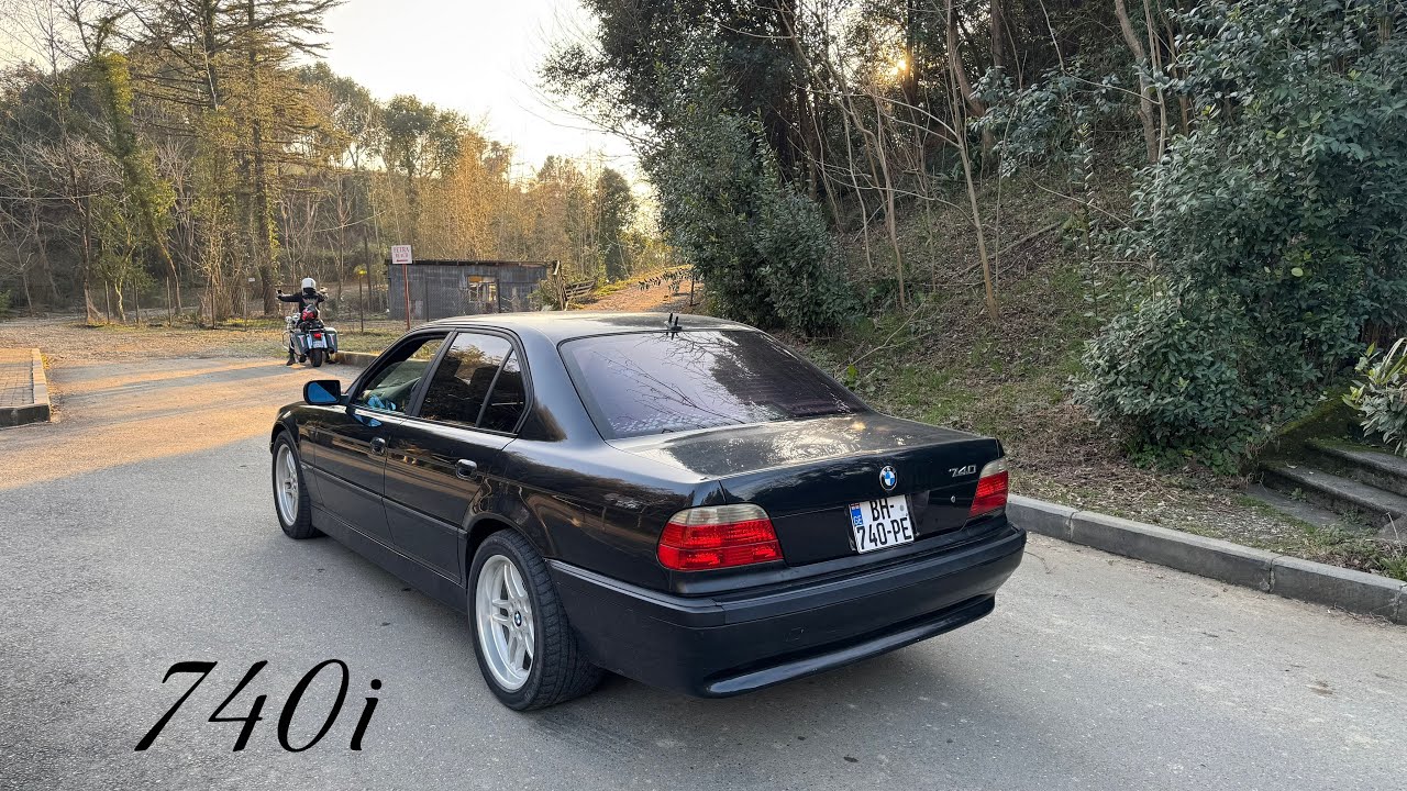 2001 BMW 740i E38 driving countryside on sunny day