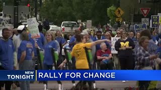 Hundreds gather for auto insurance rally in Lansing