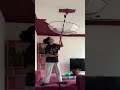 painting the ceiling of the living room of a house using an umbrella to avoid getting it in the eyes