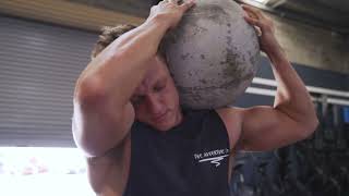 Strong Man Lifts Heavy Concrete Ball Stock Footage