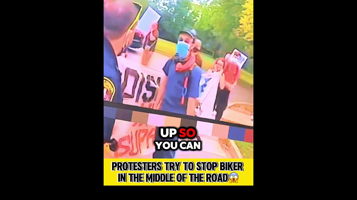 Protesters Try to Stop Biker in the Middle of the Road
