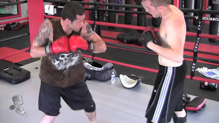 John Mercurio hitting pads with Ben Moreland