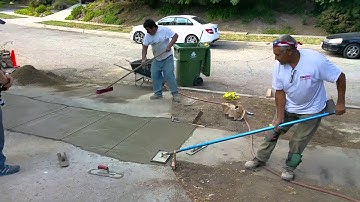 Cutting a straight line of concrete expansion joint tied into new cement slab by Shafran