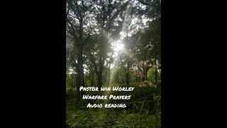 Reading from Pastor Win Worley's Warfare prayers booklet
