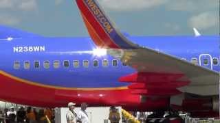 Southwest 737 C5 Galaxy Orbis And Ladies On Wing Of 4 Prop Airplane