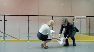 Mature Office Workers Bumping By Accident In Hall Shaking Hands Talking