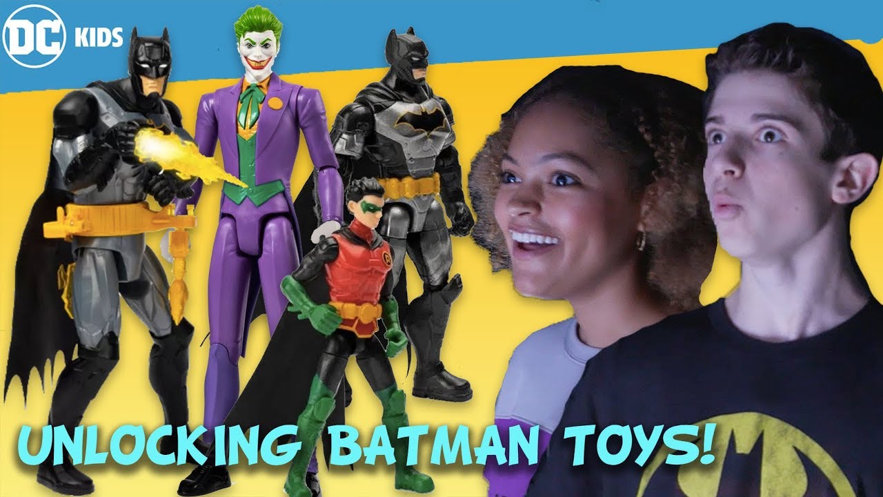 Cam girl in batman shirt plays with toys
