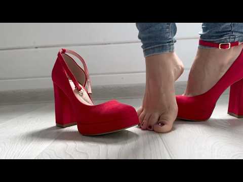 Barefoot girl puts on red shoes