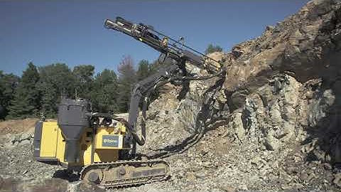 Versatile FlexiROC T30 R construction tophammer rig in action on the jobsite in Massachusetts
