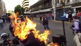 Mexican policeman set on fire during protests against fatal beating