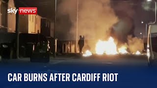 Car burns following riot sparked by a traffic collision in Cardiff